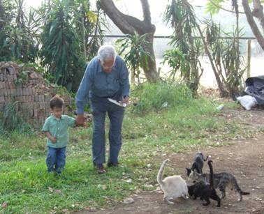 MY GRANDFATHER GIVING FOOD TO THE CATS (ON THE RANCH)