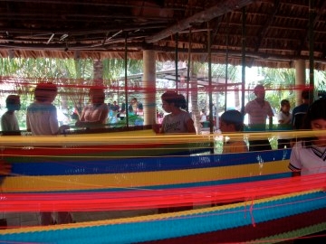 Students weaving hammocks. Weavers earn 25 dollars per hammock to support families.