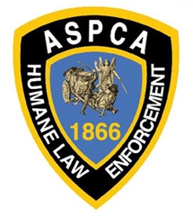 This is an ASPCA badge (http://www.aspca.org/fight-animal-cruelty/animal-precinct/ask-the-aspca-hle-agents/)