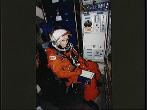 Ellen Ochoa in her space suit, inside a spaceship (NASA)