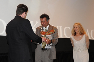 Azim Khamisa, receives his award from David Kelly, curator of the MY HERO Film Festival, alongside the Director of the Film Festival, Wendy Millette