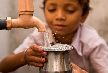 A boy getting water from a well. (marci-itsalwayssomething.blogspot.com)