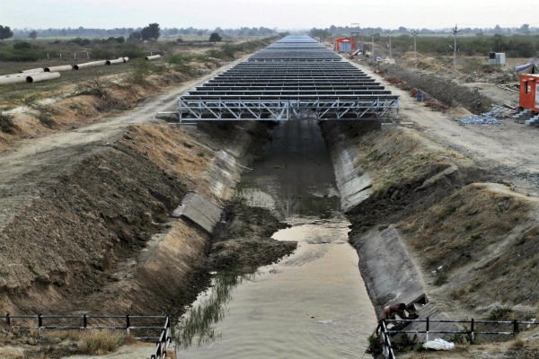Solar panels are installed atop the Narmada canal at Chandrasan village, about 25 miles from Ahmadabad, India, in February 2012. The innovative project will supply power to nearby villages while reducing evaporation of water from the canal. In rural Africa, SolarNexus offers another innovation, offering small-scale, easy-to-set-up solar systems. <P>AP Photo/Ajit Solanki