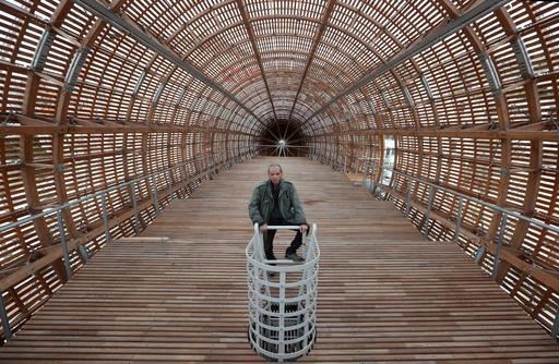 Leos Valka, a co-creator, poses for a photo inside a giant object resembling a zeppelin airship at an arts center in Prague, Czech Republic, Monday, Sept. 19, 2016. The 42-meter long and 10-meter wide ship is planned to seat some 120 people on its cascade steps. It will be used for authors' reading and debates about literature to complement exhibitions at the DOX Centre for Contemporary Art, one of the most innovative and challenging galleries in the Czech capital. (AP Photo/Petr David Josek)