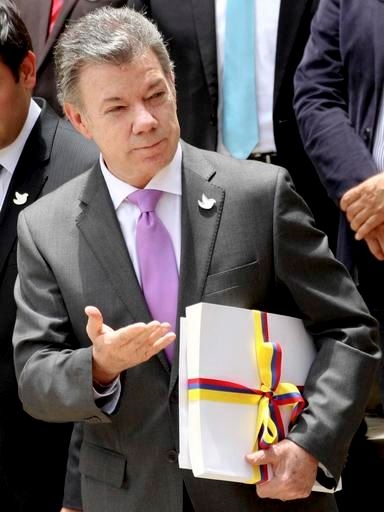 In this Thursday, Aug. 25, 2016 file photo Colombia's President Juan Manuel Santos holds the peace deal with rebels of the Revolutionary Armed Forces of Colombia, FARC after delivering it to Congress in Bogota, Colombia. Colombian President Juan Manuel Santos has won Nobel Peace Prize it was announced on Friday Oct. 7, 2016. (AP Photo/Felipe Caicedo, File)