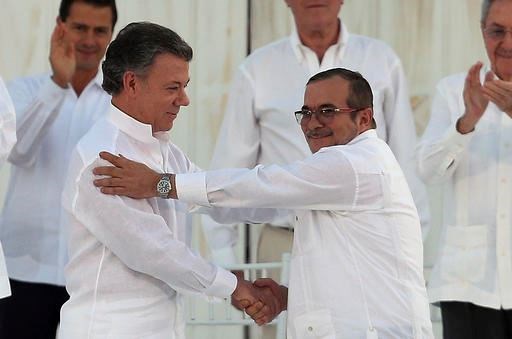 In this Monday, Sept. 26, 2016 file photo, Colombia’s President Juan Manuel Santos, left, and the top commander of the Revolutionary Armed Forces of Colombia (FARC) Rodrigo Londono, known by the alias Timochenko, shake hands after signing a peace agreement between Colombia’s government and the FARC to end over 50 years of conflict in Cartagena, Colombia. Santos won the Nobel Peace Prize Friday, Oct. 7, for his efforts to end a civil war that killed more than 200,000 Colombians. (AP Photo/Fernando Vergara, File)