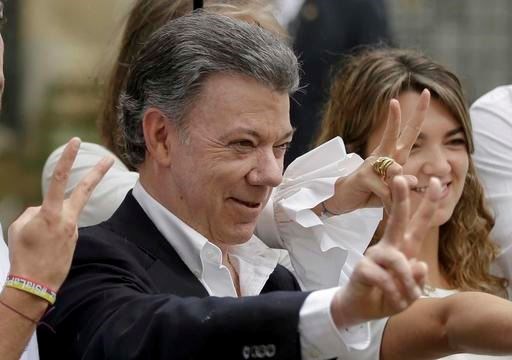 In this Sunday, Oct. 2, 2016 file photo Colombia's President Juan Manuel Santos makes the victory sign after voting in a referendum to decide whether or not to support the peace deal he signed with rebels of the Revolutionary Armed Forces of Colombia, FARC, in Bogota, Colombia. Colombian President Juan Manuel Santos has won Nobel Peace Prize it was announced on Friday Oct. 7, 2016. (AP Photo/Ricardo Mazalan, File)
