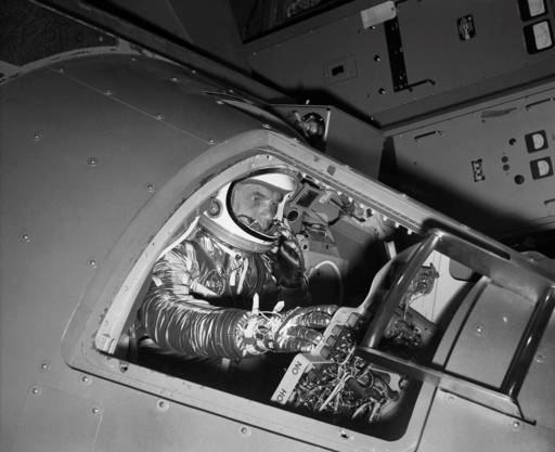In this Jan. 11, 1961 file photo, Marine Lt. Col. John Glenn reaches for controls inside a Mercury capsule procedures trainer as he shows how the first U.S. astronaut will ride through space during a demonstration at the National Aeronautics and Space Administration Research Center in Langley Field, Va. Glenn, the first American to orbit Earth who later spent 24 years representing Ohio in the Senate, died Thursday, Dec. 8, 2016, at the age of 95. (AP Photo/File)