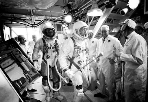 In this June 3, 1966, photo provided by NASA, Gemini IXA astronauts Eugene Cernan, left, and Tom Stafford, center, arrive in the white room atop Launch Pad 19 at Cape Kennedy Air Force Station in Cape Canaveral, Fla. NASA announced that former astronaut Cernan, the last man to walk on the moon, died Monday, Jan. 16, 2017, surrounded by his family. He was 82. (NASA via AP)