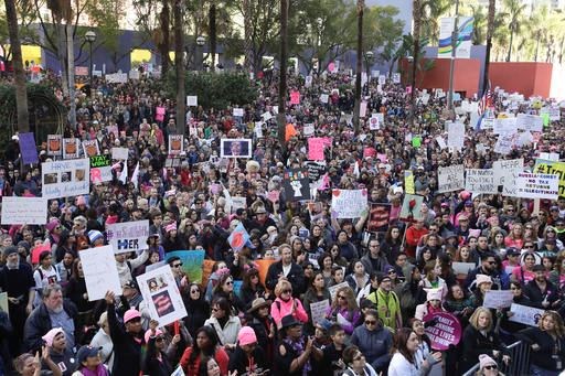Protesters listen to a speaker as they fill the streets of downtown Los Angeles during the Women's March against President Donald Trump Saturday, Jan. 21, 2017. he march was held in in conjunction with with similar events taking place in Washington and around the nation following the inauguration of President Donald Trump. (AP Photo/Jae C. Hong)