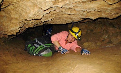 In this July 3, 2008, file photo, New Mexico Tech professor Penny Boston crawls through the Mud Turtle Passage on the way to the Snowy River formation during an expedition in Fort Stanton Cave, N.M. Boston, who discovered extreme life in New Mexico caves in 2008, presented new findings on Friday, Feb. 17, 2017 of microbes trapped in crystals in Mexico that could be 50,000 years old. (AP Photo/Susan Montoya Bryan)