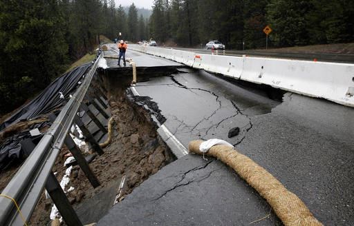 Heavy storms over the past two weeks caused parts of the shoulder and one lane of westbound Highway 50 give way, Tuesday, Feb. 21, 2017, near Pollock Pines, Calif. Crews have one lane open, of the four lane highway, as they work to repair the hole that is about 40 feet long and 17 feet wide on one of the main routes to Lake Tahoe. (AP Photo/Rich Pedroncelli)