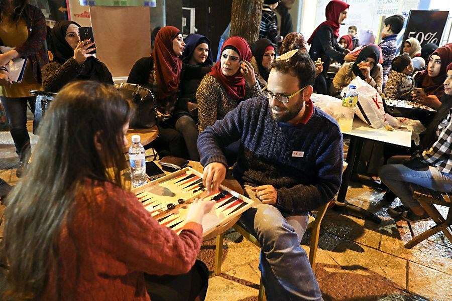 A man and woman compete Feb. 27 in a backgammon championship in Jerusalem organized by Double Yerushalmi, a group trying to build closer ties between Arabs and Jews through cultural activities. (Ammar Awad/Reuters)