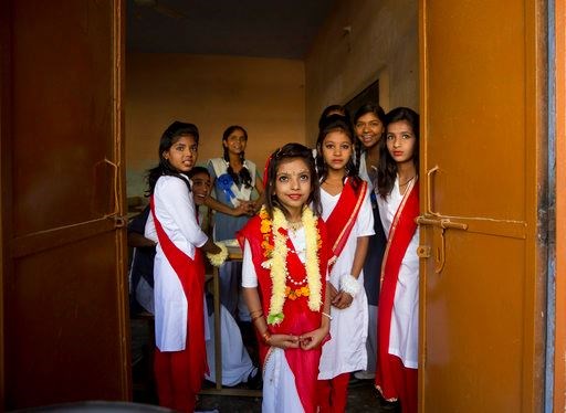 Schoolchildren wait to perform during the inauguration ceremony of a water filtration tower at their school in Nai Basti Village, some 55 kilometers (35 miles) from in New Delhi, India, Wednesday, March 22, 2017. In Nai Bastti access to clean drinking water was a dream for the villagers till Wednesday, when the water filtration plant began functioning in an elementary school in the village. India has the world's highest number of people without access to clean water. UNICEF says nearly 78 million Indians - about 5 percent of the country's 1.3 billion population - must make do with contaminated water sources or buy water at high rates. (AP Photo/Manish Swarup)