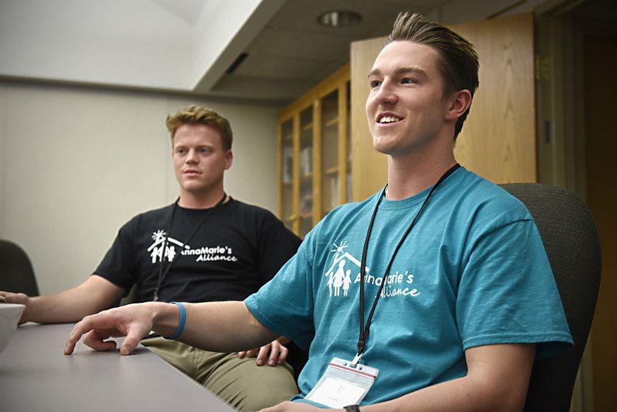 St. John’s University football team members Cody Kohout (l.) and Will Gillach talk about their work as volunteers at Anna Marie’s Aliance in St. Cloud, Minn. (Dave Schwarz/St. Cloud Times/AP)