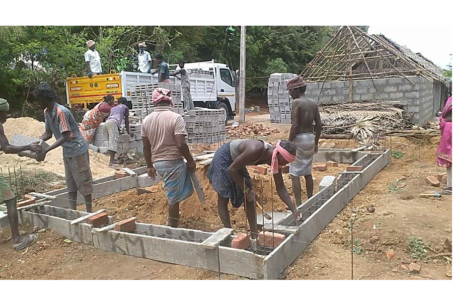 Rescued bonded laborers work with students and contractors to build their first homes in Annaisathyanagar village in the southern Indian state of Tamil Nadu in 2016. (Photo: Madras Christian College)