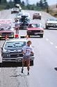 Terry Fox with cars behind him