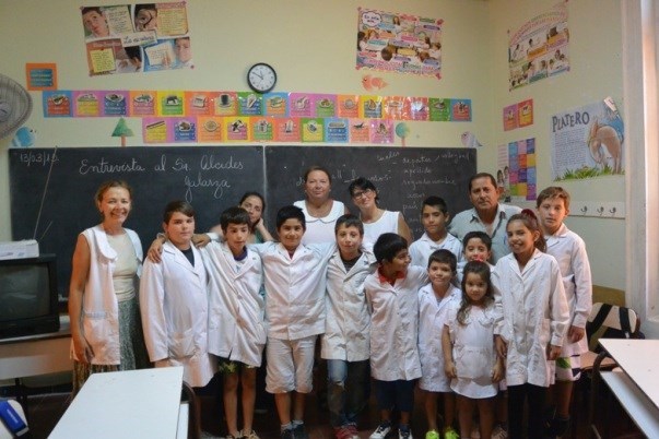Students and staff of Isla Martín García with Anusia on the left, principal Rosana Paoletta in the center and community hero, Alcidez Galarza on the right (Photo by Annie Merkley)