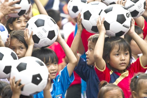 Thai school children hold soccer balls in Bangkok, Thailand. A special soccer ball for use in developing countries called the SOCCKET contains a generator and lamp inside for use in areas without electricity.  <P>David Longstreath/AP/File