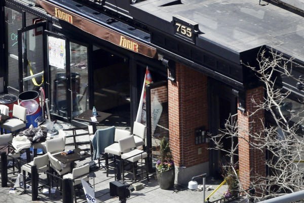 An April 16 photo shows the front of the Forum restaurant, the scene of one of two bombings near the finish line of the 2013 Boston Marathon, the next day. Patrons praised restaurant employees for quick action in keeping them calm and helping them evacuate using a back stairway. One patron saw staffers bring towels and help tend the wounded. <P>Elise Amendola/AP/File