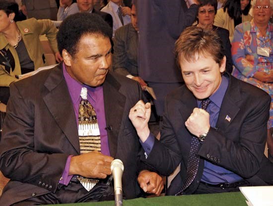 Michael J Fox (right) with Parkinson Patient Muha (http://positivelyparkinsons.blogspot.com/2010_11_01_archive.html)