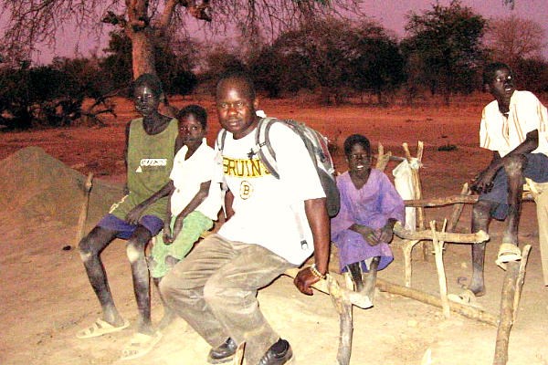 Franco Majok (center, in Bruins shirt) fled from war-torn Sudan and found his way to the US. But after a return visit in 2005 he was moved to create Village Help for South Sudan, which has built a school and other projects in two villages there.  <P>Courtesy of Ron Moulton