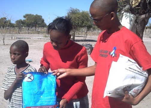 GSS Student Leader, Benson, assists village child (http://ads-gss.blogspot.com/)