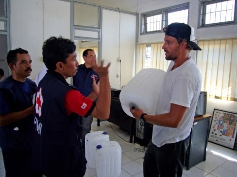 Jon Rose, right, and Alfri, a local Red Cross worker in the city of Padang, discuss how to make the plastic gas canisters work as water filters.<br>Photo courtesy of Jon Rose