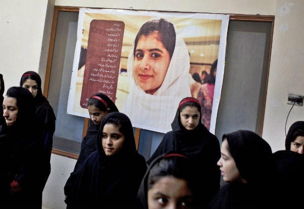 Pakistani girls gather under a poster of Malala Yousufzai in her old school in Mingora, Swat Valley, Pakistan.	 <P>(Anja Niedringhaus/AP)