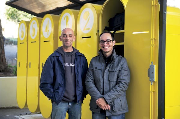 Duarte Paiva (r.) stands with Jorge Toledo in front of the lockers he designed for homeless people in Lisbon to store their treasured possessions.