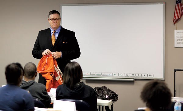 Sam Bracken, with his orange duffel bag, addresses teenagers in an Orange Duffel Bag Initiative class in Atlanta.  <P>Courtesy of Sam Bracken/Orange Duffel Bag Initiative