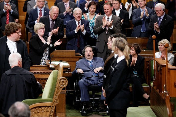 Liberal MP Mauril Bélanger receives a standing ovation yesterday after the approval of his bill to make the national anthem gender neutral - Chris Wattie/Reuters